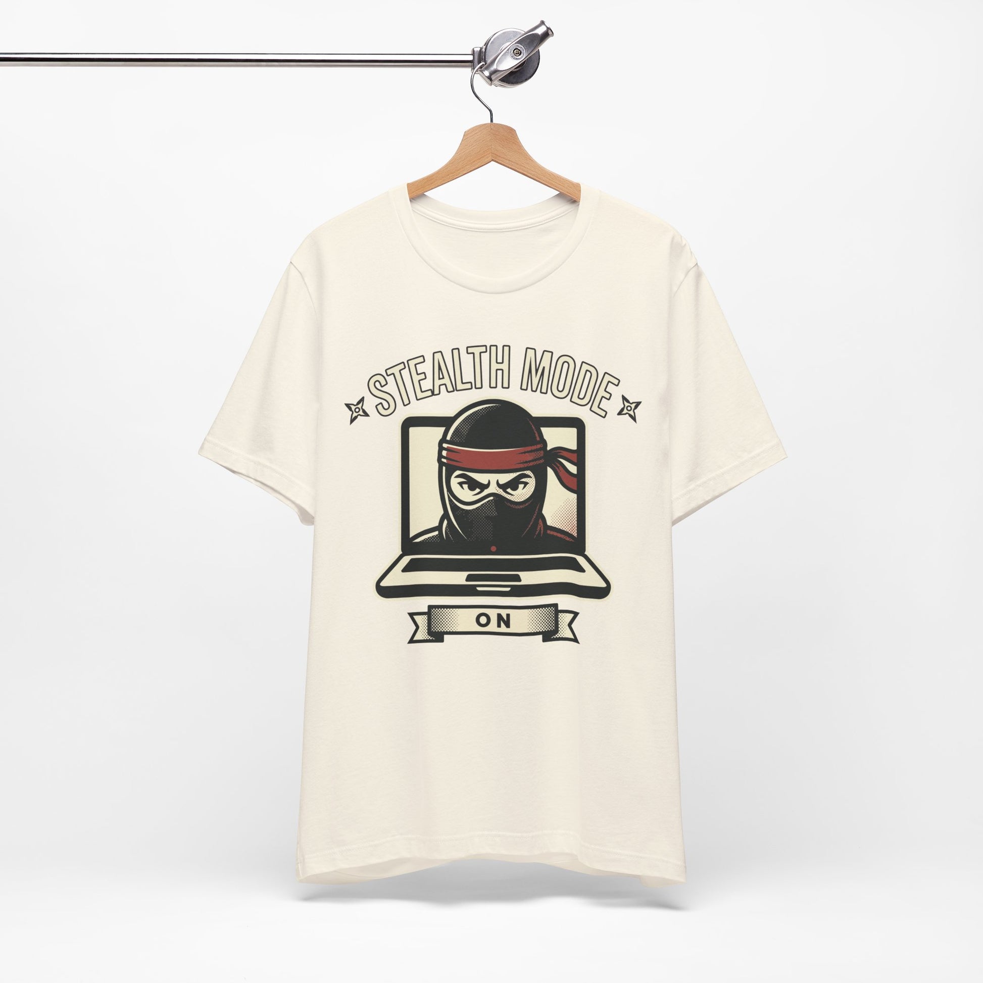 Red Bella+Canvas 3001 unisex tee with Stealth Mode On ninja laptop graphic, flat lay