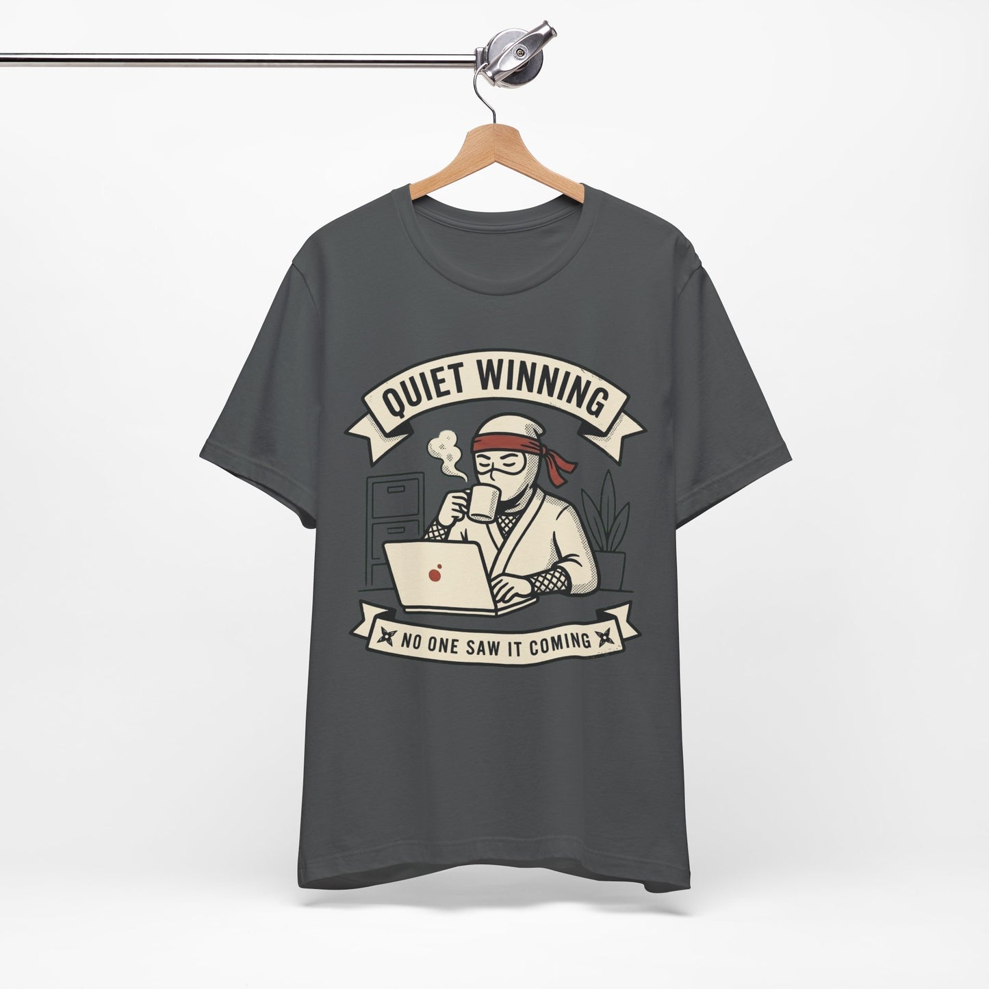 Red Bella+Canvas 3001 unisex tee with Quiet Winning ninja laptop design, flat lay