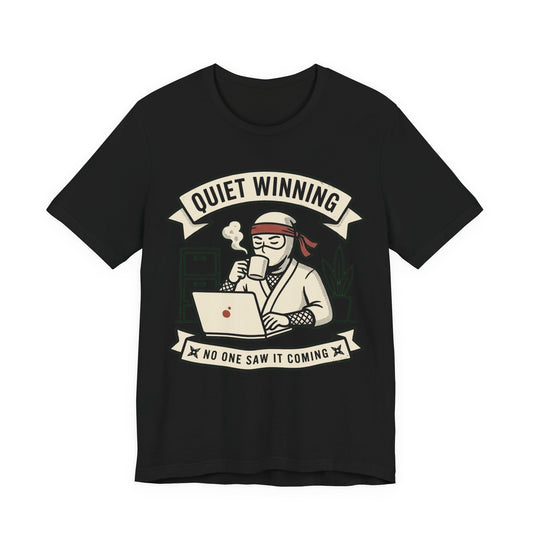 Black Bella+Canvas 3001 unisex tee with Quiet Winning ninja laptop design, flat lay