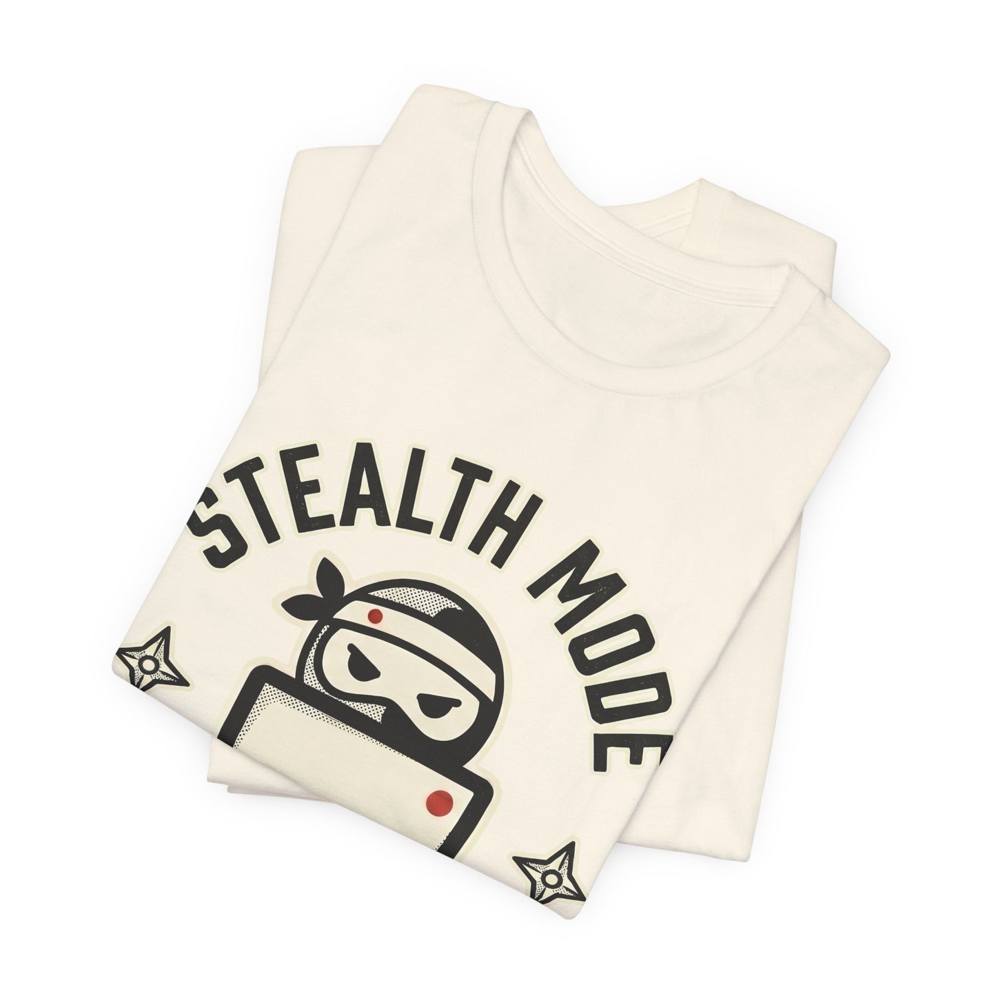 Natural Bella+Canvas 3001 unisex tee with Stealth Mode On ninja laptop badge graphic, on hanger