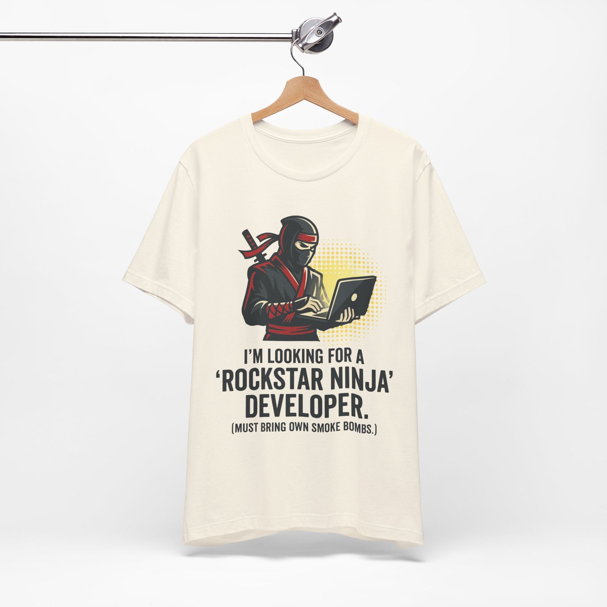 Red Bella+Canvas 3001 unisex tee with Rockstar Ninja Developer graphic and text design, flat lay