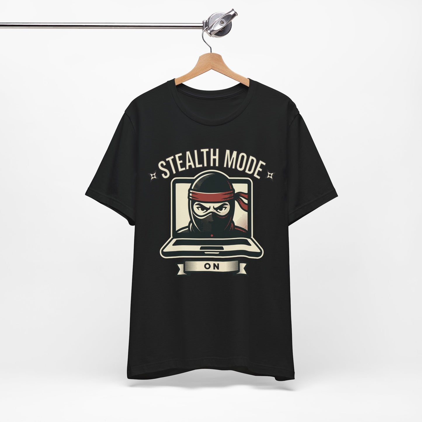 Natural Bella+Canvas 3001 unisex tee with Stealth Mode On ninja laptop graphic, flat lay