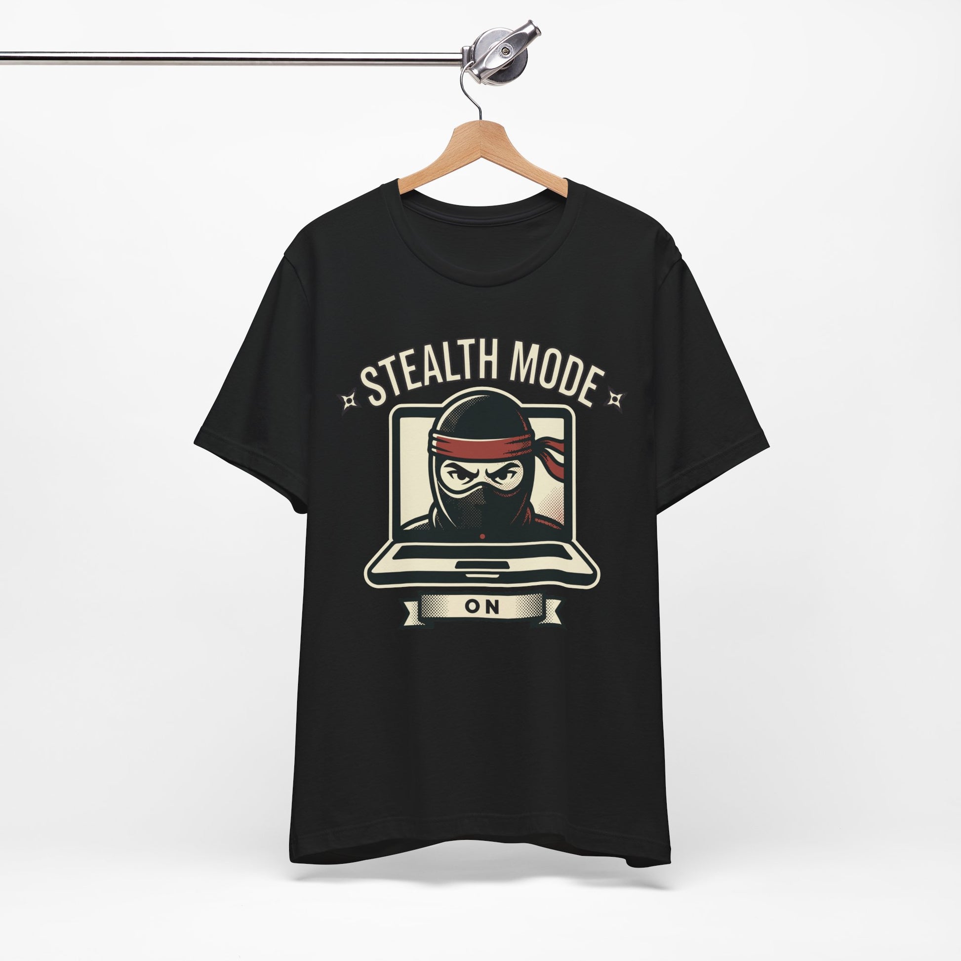 Natural Bella+Canvas 3001 unisex tee with Stealth Mode On ninja laptop graphic, flat lay