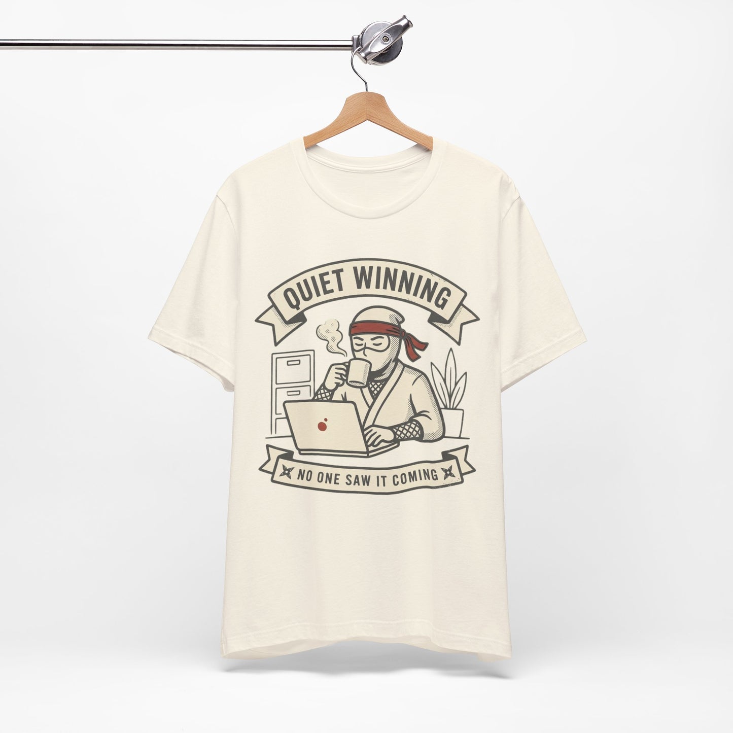 Red Bella+Canvas 3001 unisex tee with Quiet Winning ninja laptop design, flat lay