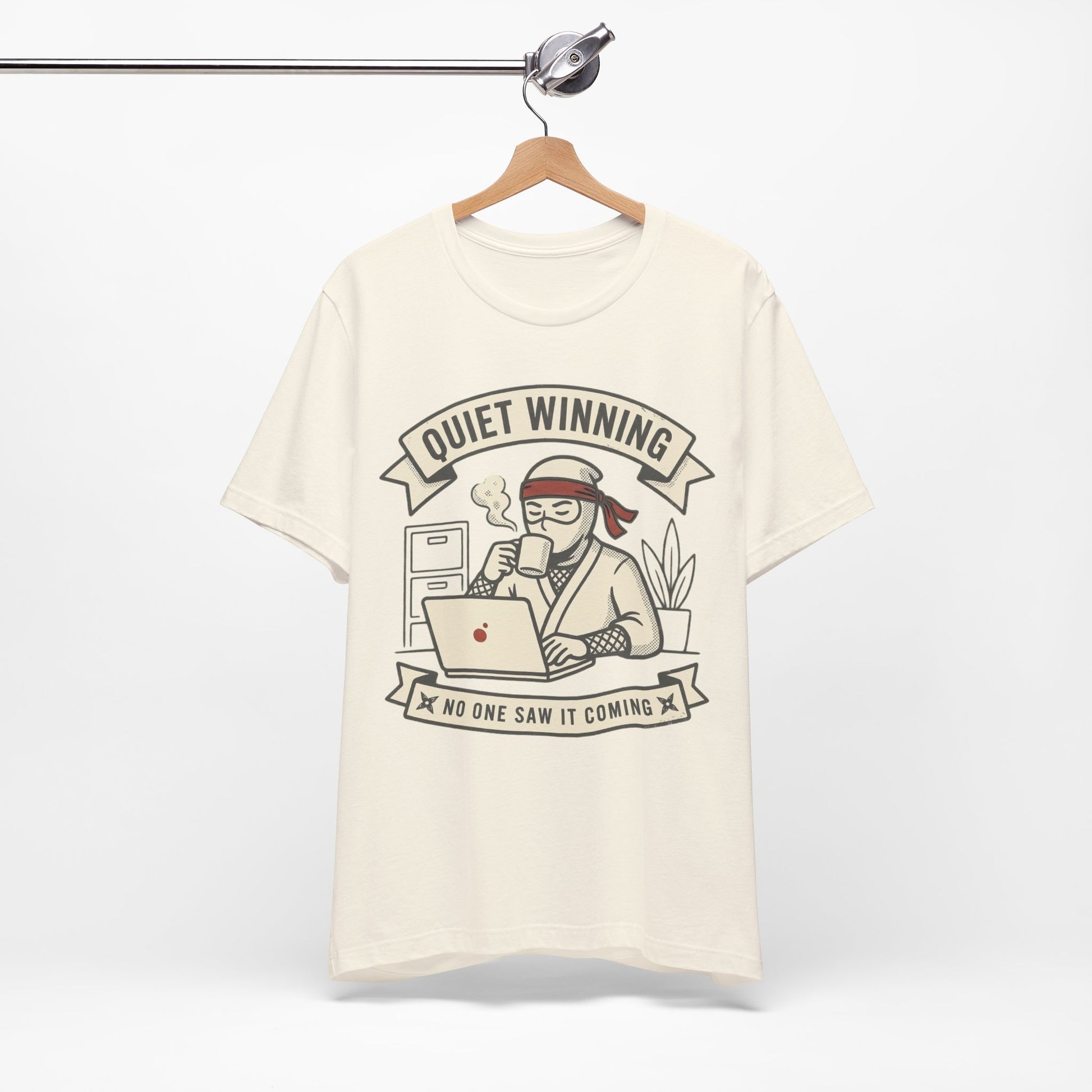 Red Bella+Canvas 3001 unisex tee with Quiet Winning ninja laptop design, flat lay