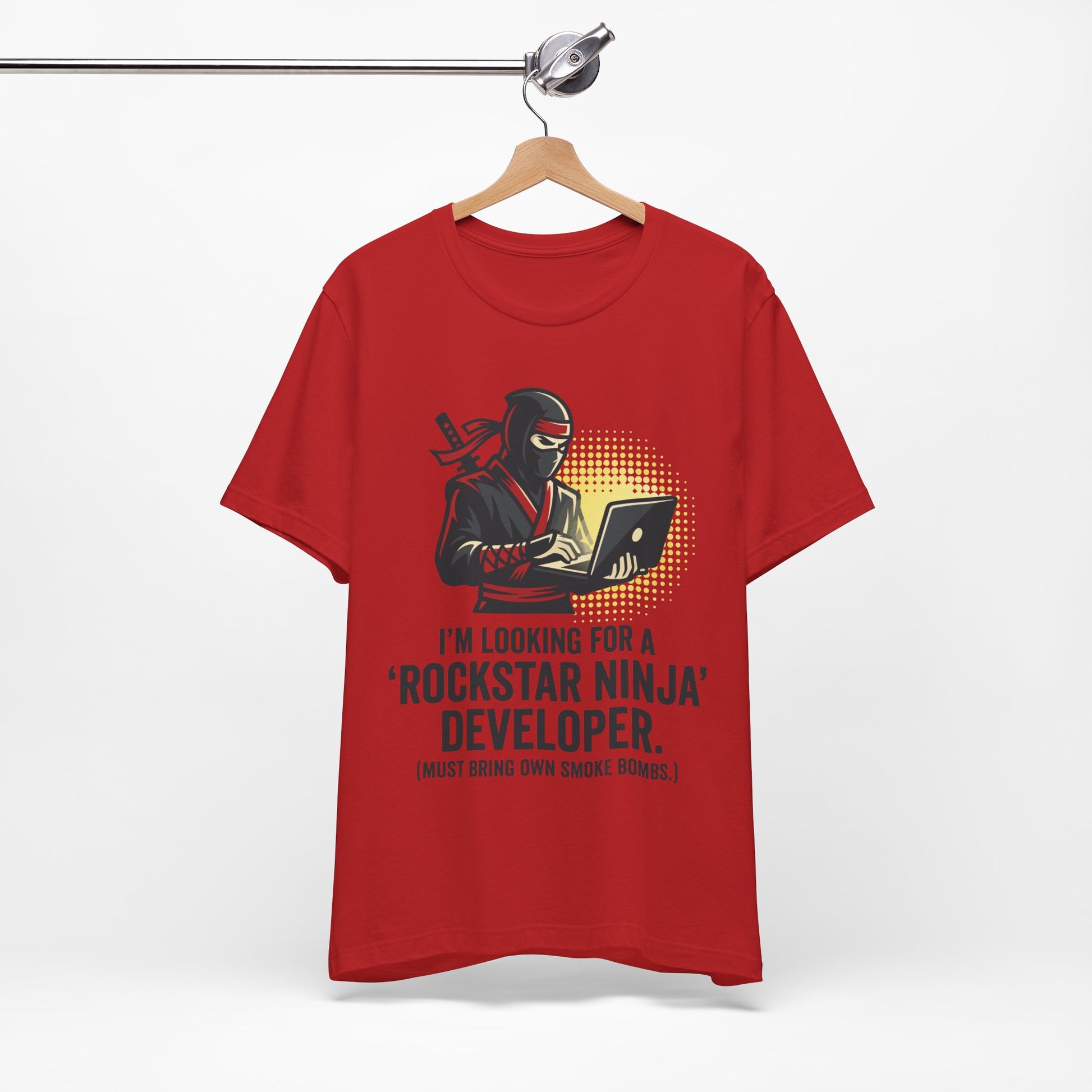 Steel Blue Bella+Canvas 3001 unisex tee with Rockstar Ninja Developer graphic and text design, flat lay